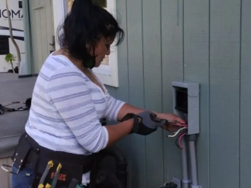 Licensed electrician wiring an exterior subpanel in Myrtle Creek
